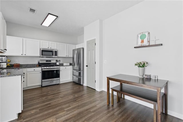 kitchen with white cabinetry, dark wood-type flooring, visible vents, and stainless steel appliances