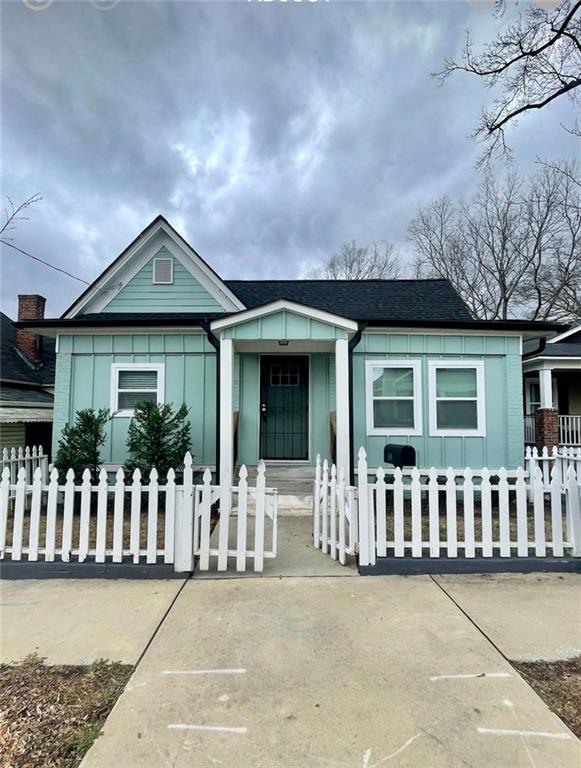 view of front of house with board and batten siding and a fenced front yard