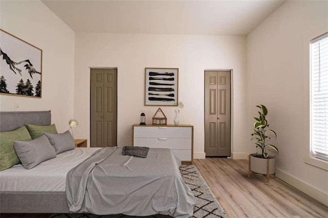 480 James P Brawley Dr NW, Atlanta, GA 30318 - bedroom featuring multiple windows, baseboards, and light wood-type flooring