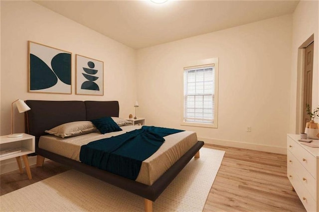 bedroom featuring baseboards and light wood-style floors