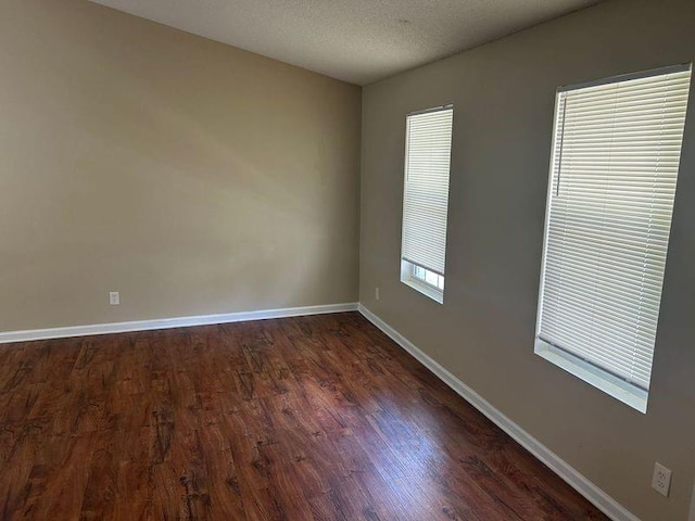 6536 Rebecca Lou Ln, Lithonia, GA 30058 - spare room with baseboards, dark wood finished floors, and a textured ceiling