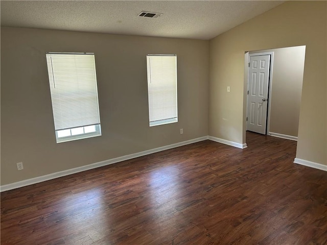 6536 Rebecca Lou Ln, Lithonia, GA 30058 - empty room featuring dark wood-type flooring, baseboards, and vaulted ceiling
