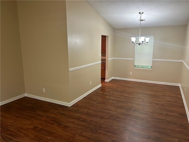 6536 Rebecca Lou Ln, Lithonia, GA 30058 - unfurnished room with a chandelier, dark wood finished floors, baseboards, and vaulted ceiling