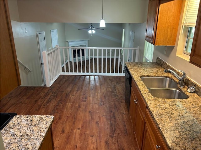 6536 Rebecca Lou Ln, Lithonia, GA 30058 - kitchen with a sink, brown cabinets, ceiling fan, dark wood-style floors, and light stone countertops