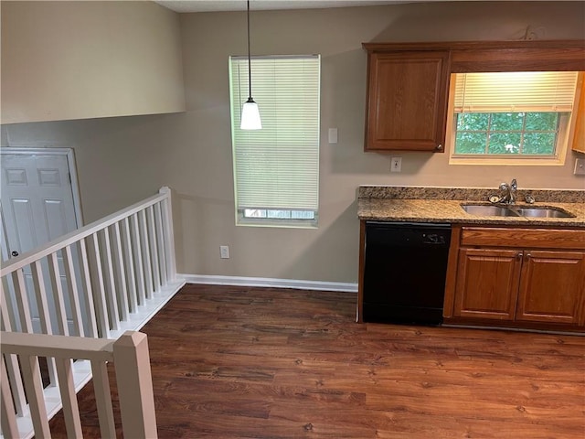 6536 Rebecca Lou Ln, Lithonia, GA 30058 - kitchen featuring dishwasher, a sink, dark wood-style flooring, brown cabinets, and hanging light fixtures
