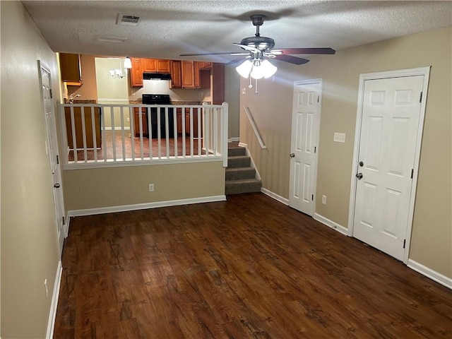 6536 Rebecca Lou Ln, Lithonia, GA 30058 - unfurnished living room with dark wood-style floors, ceiling fan, stairway, a textured ceiling, and baseboards