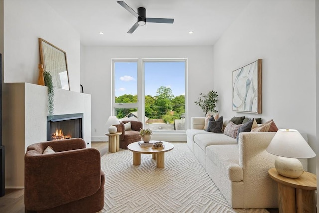 living room with light wood-type flooring and ceiling fan