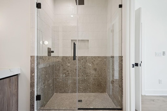 bathroom featuring an enclosed shower and vanity