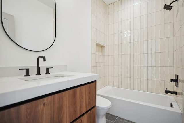 full bathroom featuring vanity, tile patterned floors, toilet, and tiled shower / bath