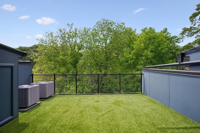 view of yard with a balcony and central AC unit