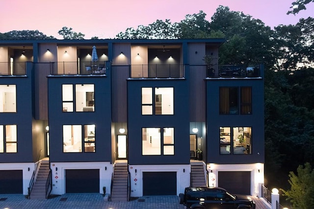 view of front of house with a garage and a balcony