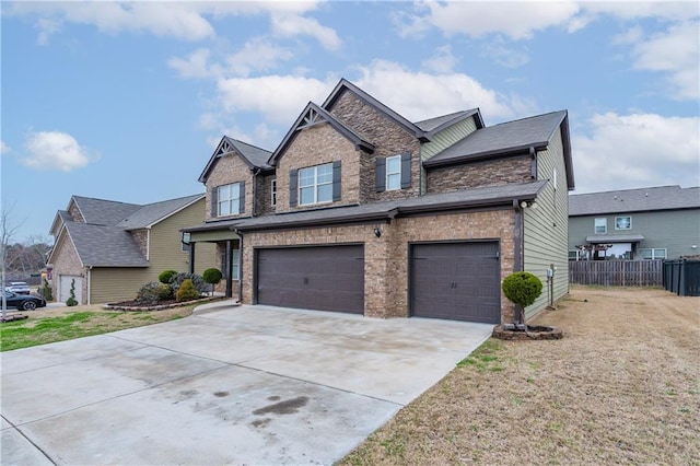 craftsman-style home featuring a garage, concrete driveway, brick siding, and fence