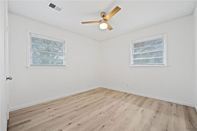 empty room with light hardwood / wood-style flooring, ceiling fan, and ornamental molding