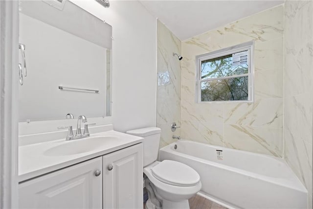 full bathroom with toilet, vanity, and tiled shower / bath