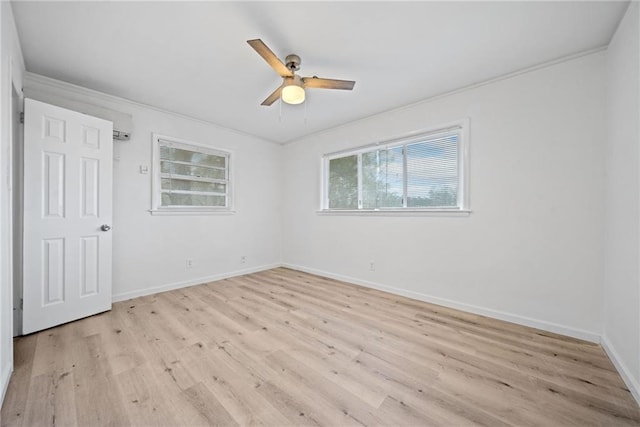 spare room with light wood-type flooring, ceiling fan, and crown molding