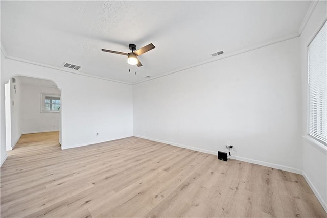 unfurnished room featuring a textured ceiling, light hardwood / wood-style floors, ceiling fan, and crown molding