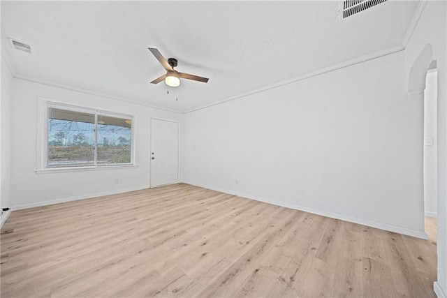 empty room featuring crown molding, light hardwood / wood-style flooring, and ceiling fan