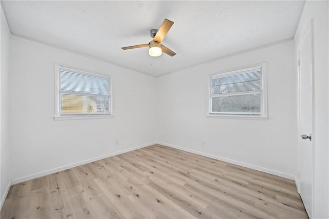 spare room featuring ceiling fan, crown molding, and light hardwood / wood-style flooring