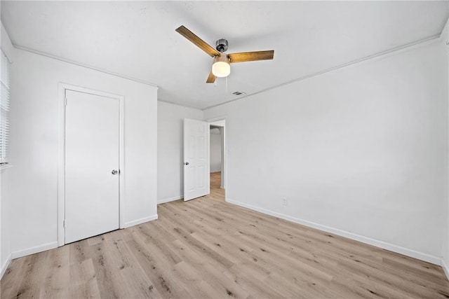 unfurnished bedroom with ceiling fan, ornamental molding, and light hardwood / wood-style flooring