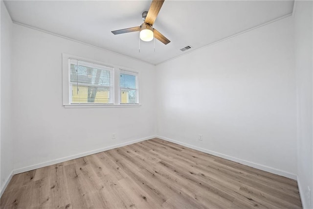 empty room featuring light wood-type flooring, ceiling fan, and ornamental molding