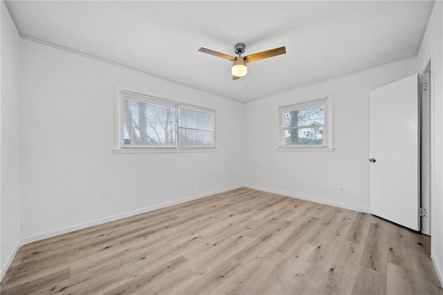 empty room featuring light wood-type flooring, ceiling fan, and crown molding