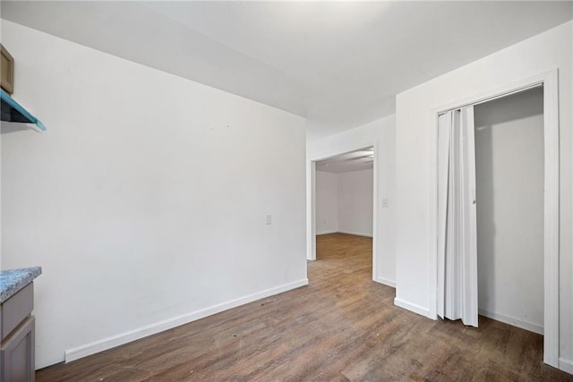 interior space featuring dark hardwood / wood-style flooring and a closet