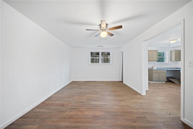 empty room with ceiling fan and wood-type flooring