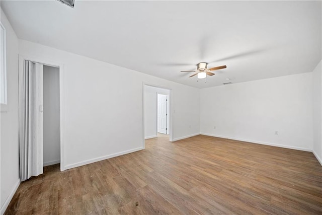 unfurnished room featuring ceiling fan and wood-type flooring