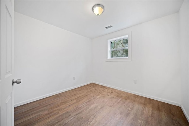 unfurnished room featuring wood-type flooring