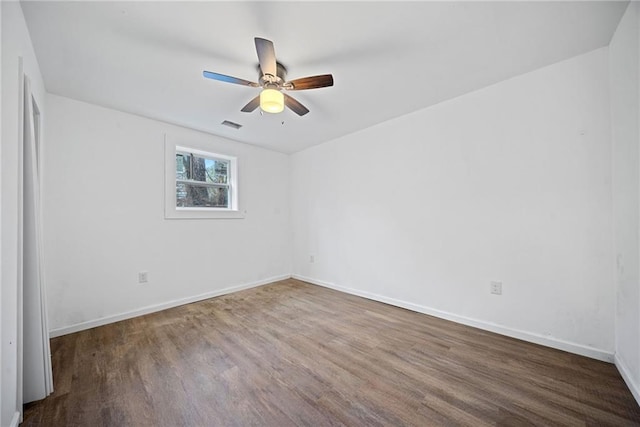 empty room featuring ceiling fan and dark hardwood / wood-style flooring