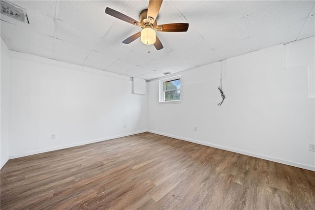 basement with hardwood / wood-style flooring and ceiling fan