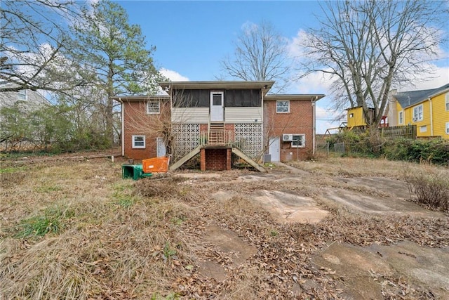 back of property with a sunroom