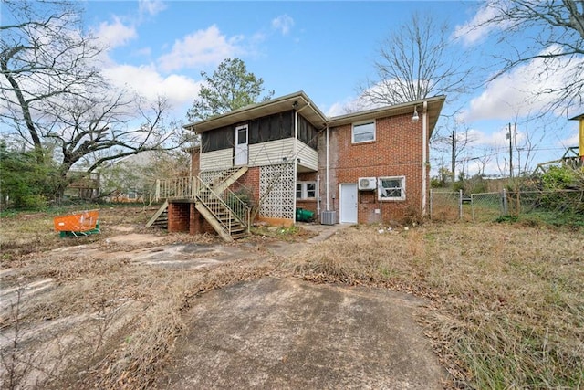 rear view of house featuring a sunroom