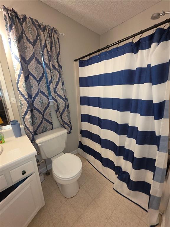 77 Ben W Dr, Cedartown, GA 30125 - bathroom featuring a textured ceiling, vanity, and a shower with curtain