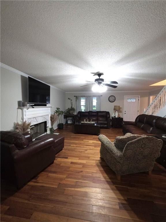 77 Ben W Dr, Cedartown, GA 30125 - living area with ceiling fan, ornamental molding, wood finished floors, a textured ceiling, and a high end fireplace