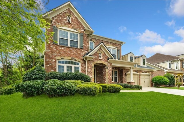 view of front of house with driveway, a front lawn, and brick siding