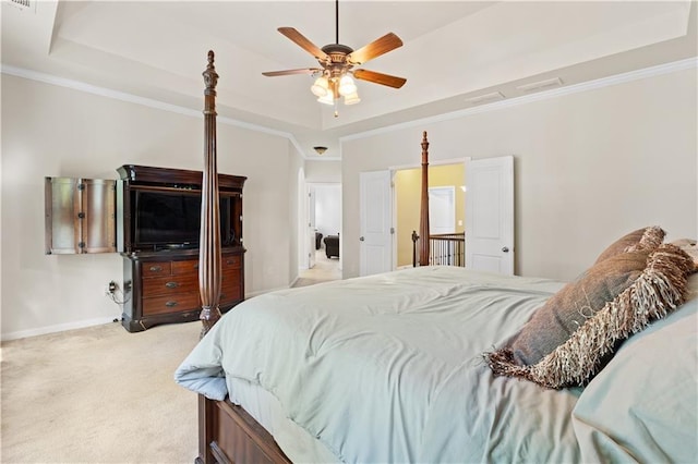 bedroom with a raised ceiling, light carpet, crown molding, and baseboards