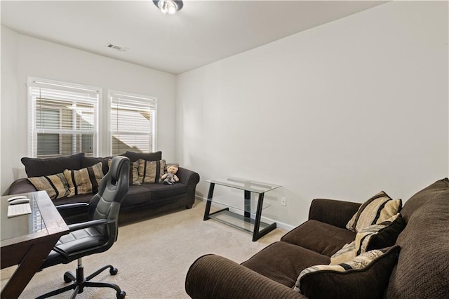 office space featuring visible vents, light colored carpet, and baseboards
