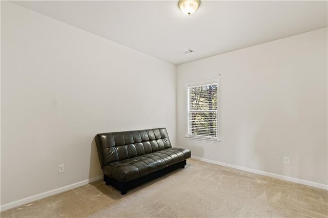 sitting room featuring visible vents, baseboards, and carpet floors