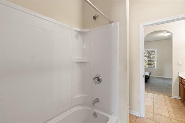 bathroom with tile patterned floors, vanity, shower / tub combination, and baseboards