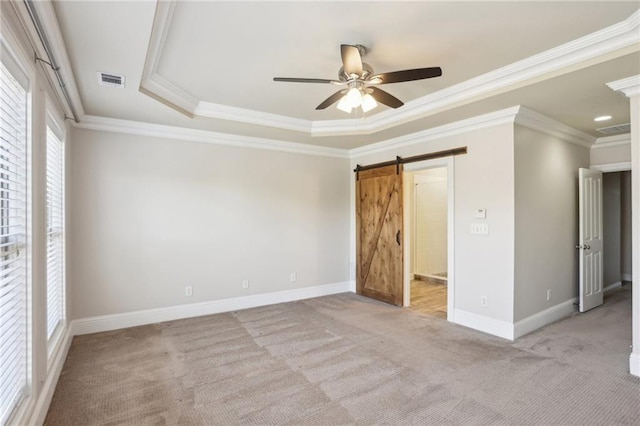 345 Alderwood Ln, Sandy Springs, GA 30328 - unfurnished bedroom featuring light colored carpet, crown molding, baseboards, a barn door, and a raised ceiling