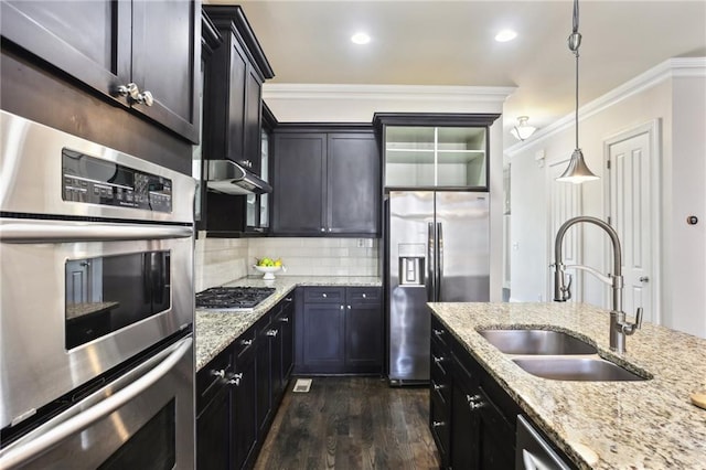 345 Alderwood Ln, Sandy Springs, GA 30328 - kitchen with stainless steel appliances, a sink, dark wood-style floors, ornamental molding, and decorative backsplash