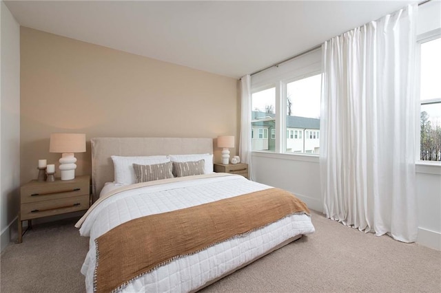bedroom with baseboards and carpet flooring