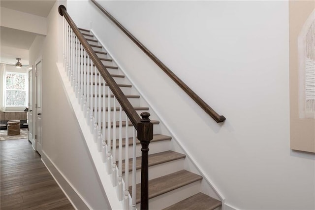 stairs featuring baseboards and wood finished floors