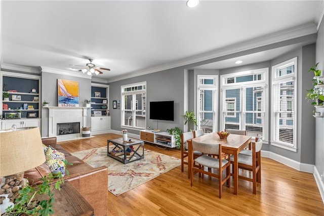 1912 Hosea L Williams Dr NE Unit 1, Atlanta, GA 30317 - living room with healthy amount of natural light, a fireplace with flush hearth, crown molding, ceiling fan, and light wood-style flooring