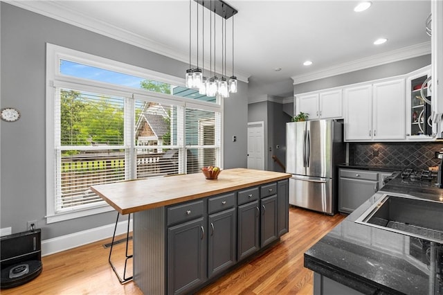 1912 Hosea L Williams Dr NE Unit 1, Atlanta, GA 30317 - kitchen with freestanding refrigerator, wood counters, white cabinets, decorative backsplash, and light wood-type flooring