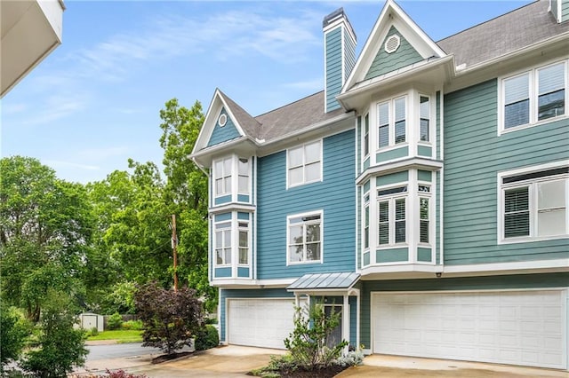 1912 Hosea L Williams Dr NE Unit 1, Atlanta, GA 30317 - view of front facade with an attached garage, driveway, and a chimney
