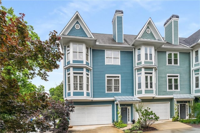 1912 Hosea L Williams Dr NE Unit 1, Atlanta, GA 30317 - view of front facade with an attached garage, driveway, and a chimney
