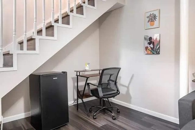 home office with dark hardwood / wood-style floors