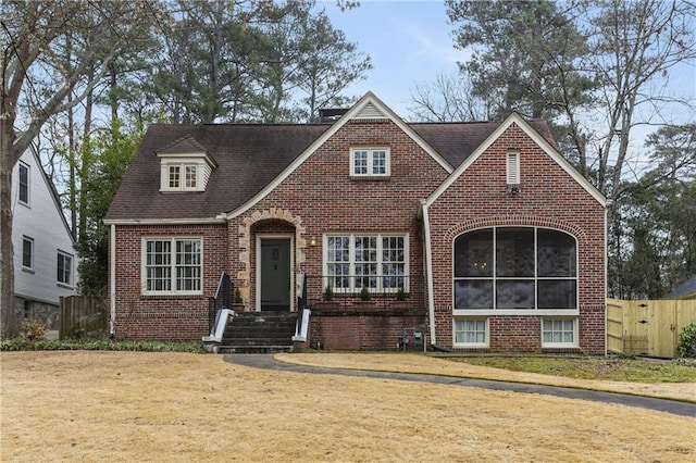 view of front facade featuring a front yard and a sunroom